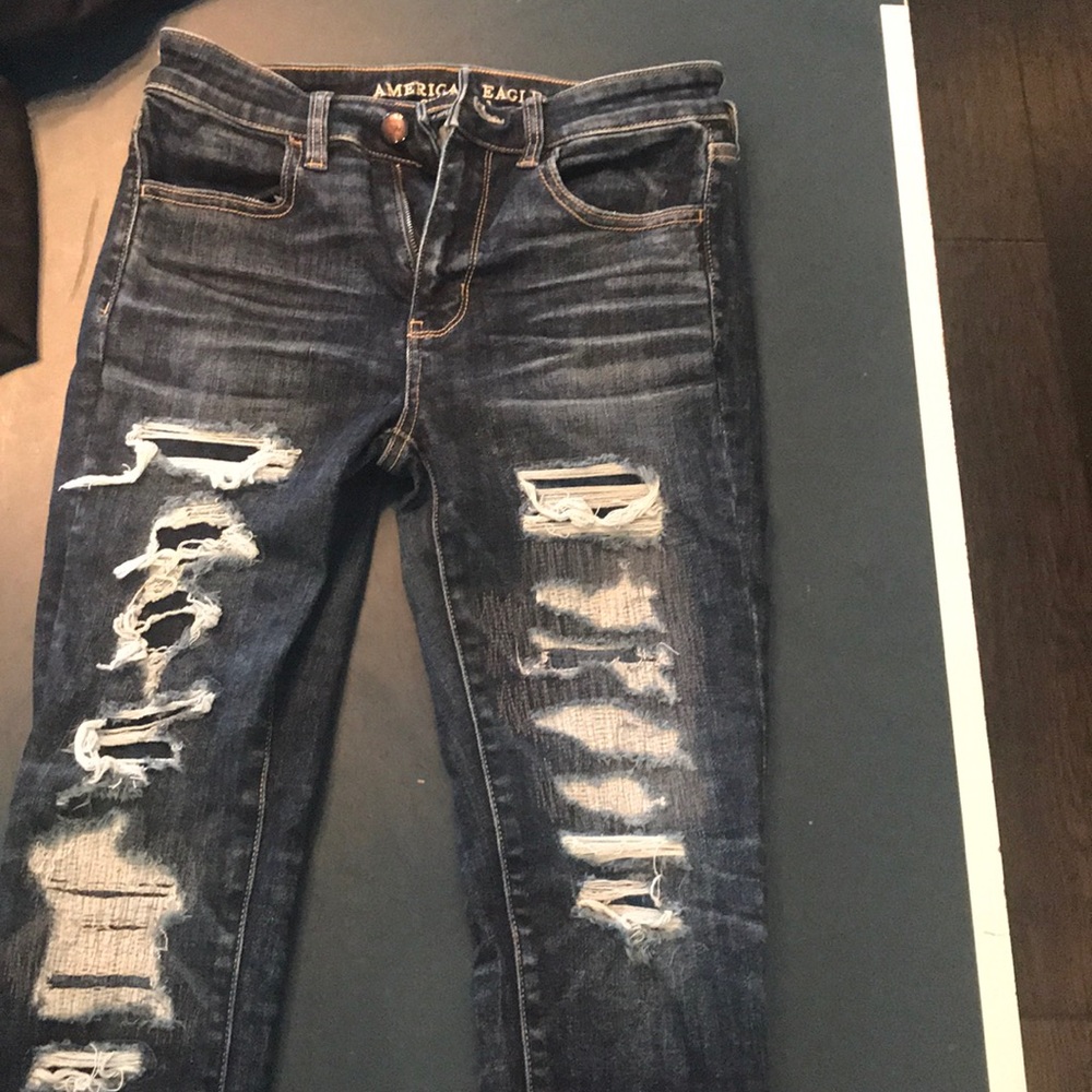 Distressed dark denim jeans